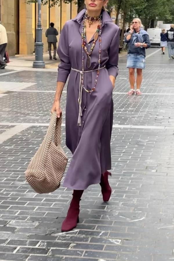Satin shirt dress with a fitted waist and side slit.
