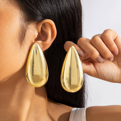 Geometric Gold Drop Earrings With Twisted Design